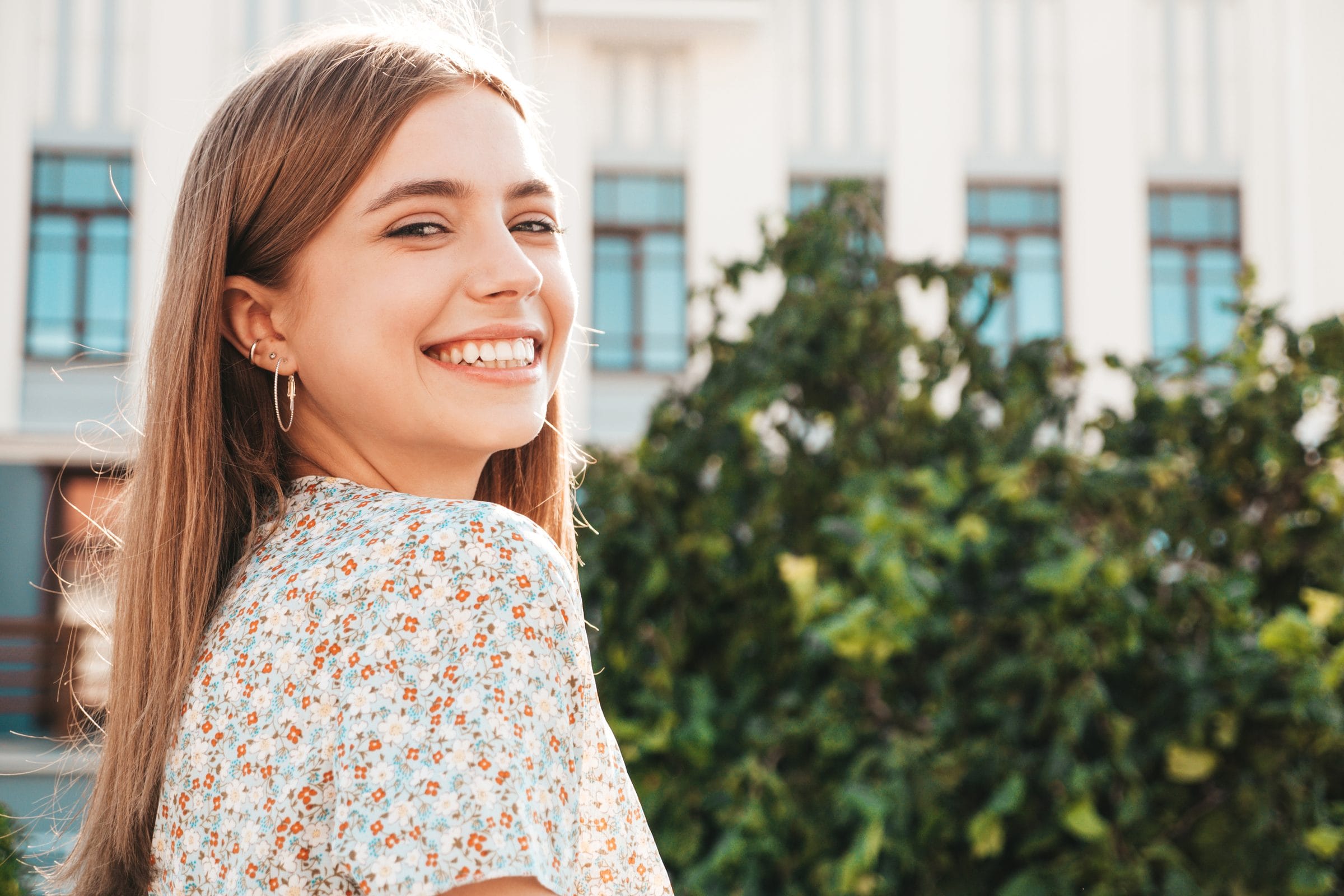 A young woman smiling outdoors