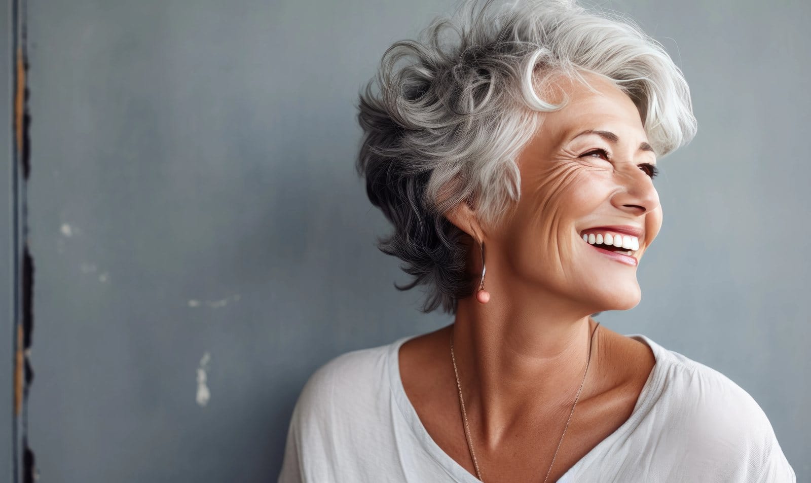 A smiling older woman with short grey hair